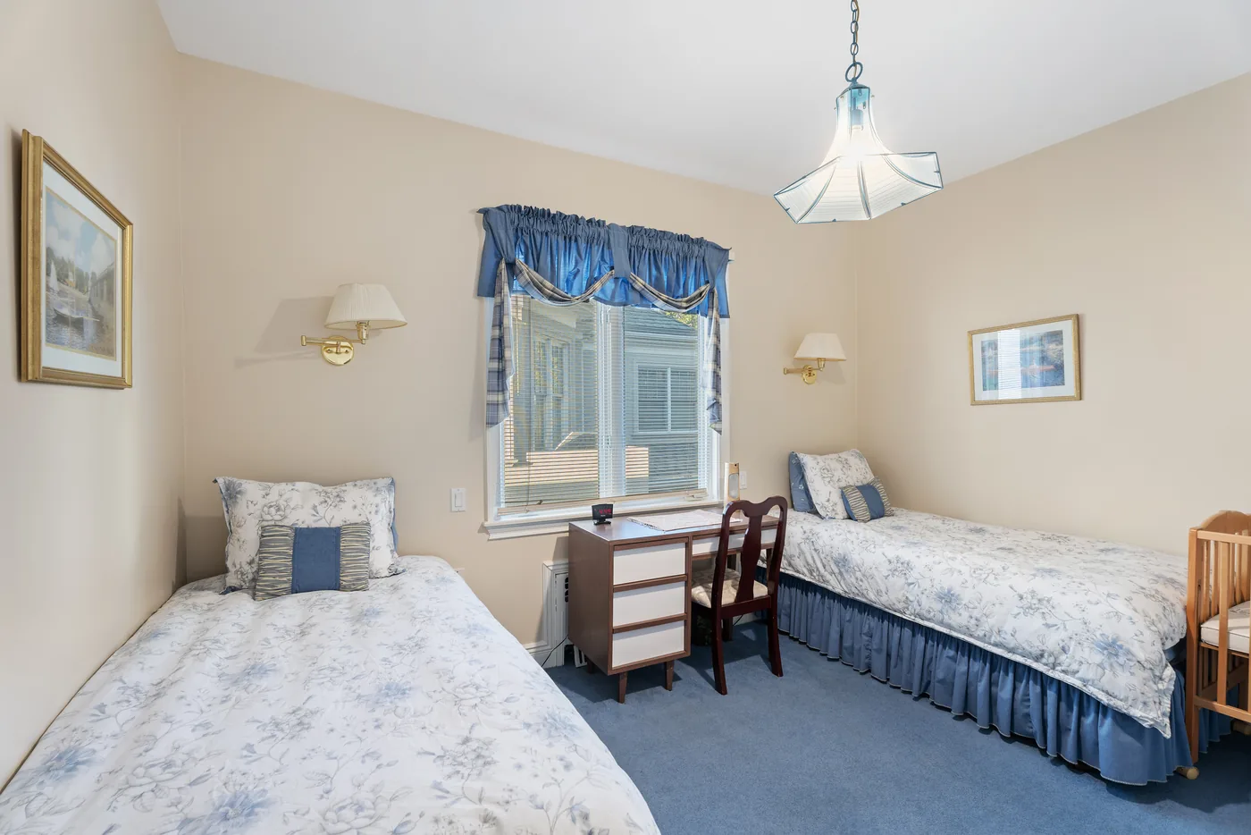 Blue twin bedroom photographed for a New York City real estate listing.