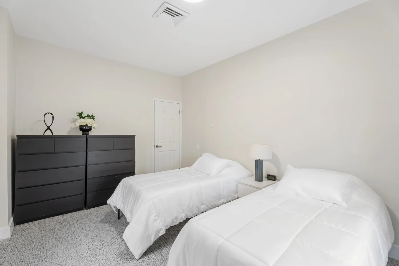 Bright bedroom with twin beds photographed for a New York City real estate listing.