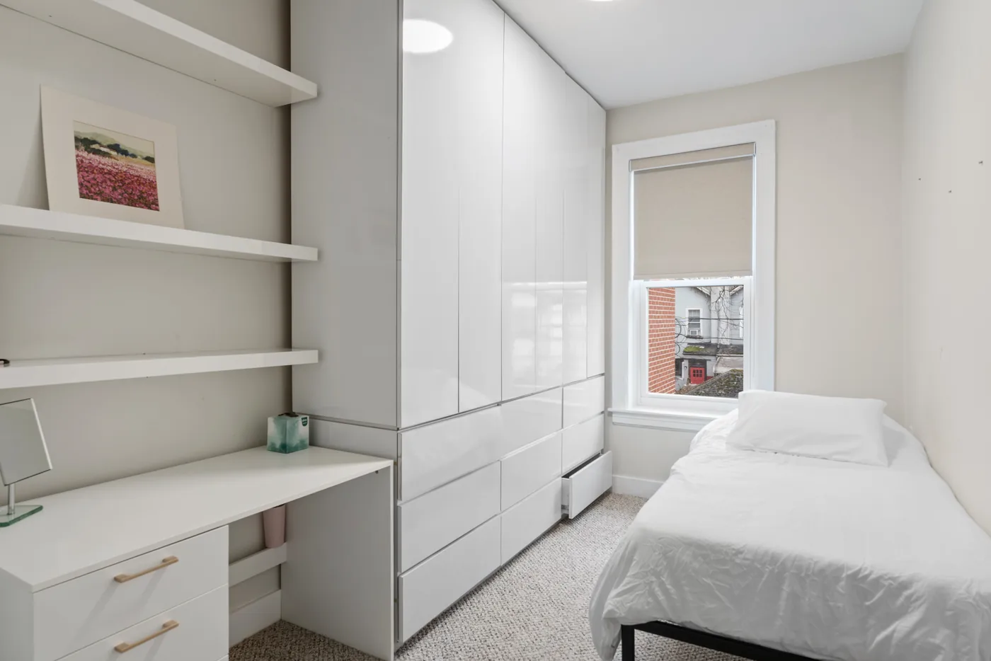 Bedroom with built-in storage and desk photographed for a New York City real estate listing.