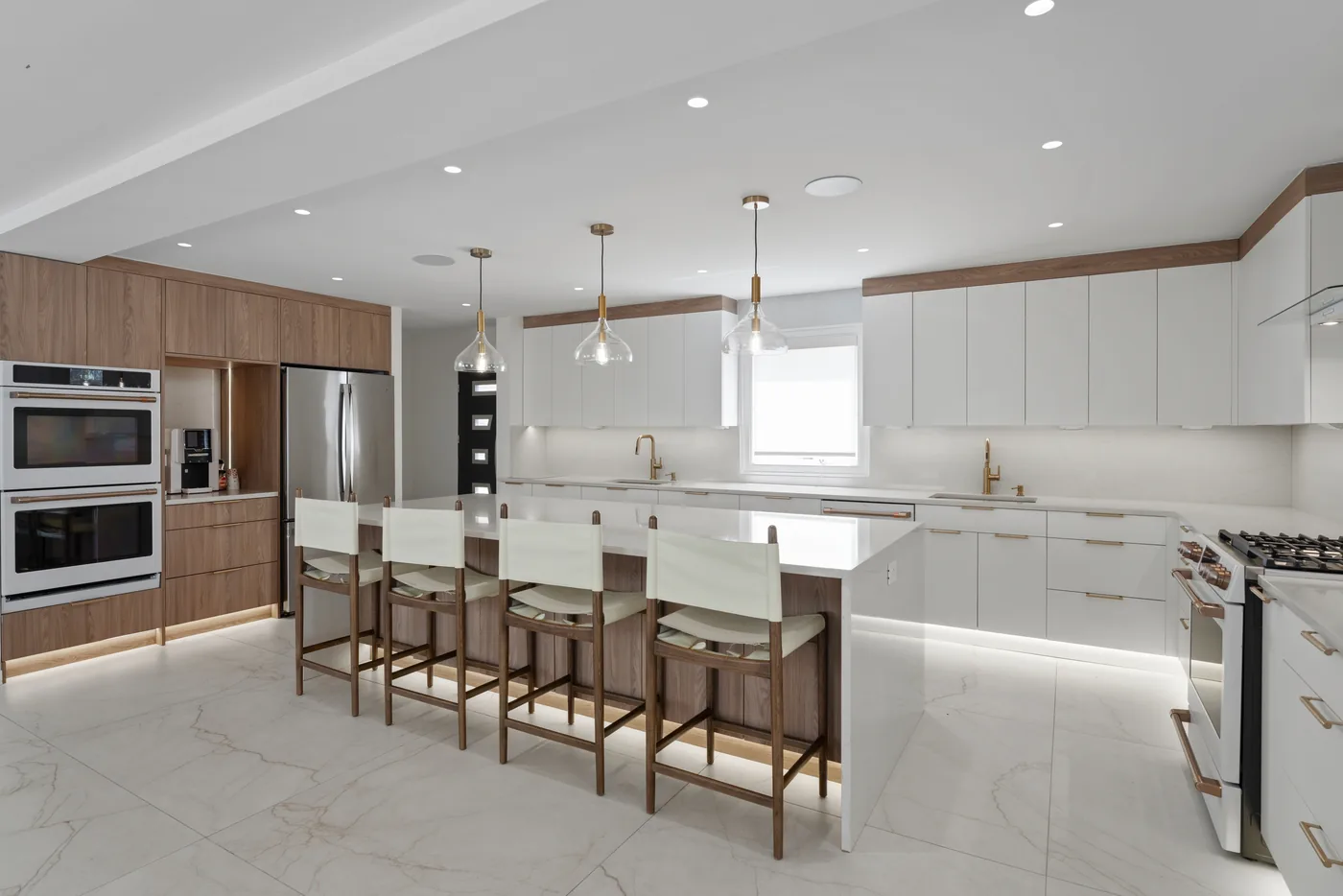 Modern white kitchen with island seating photographed for a New York City real estate listing.