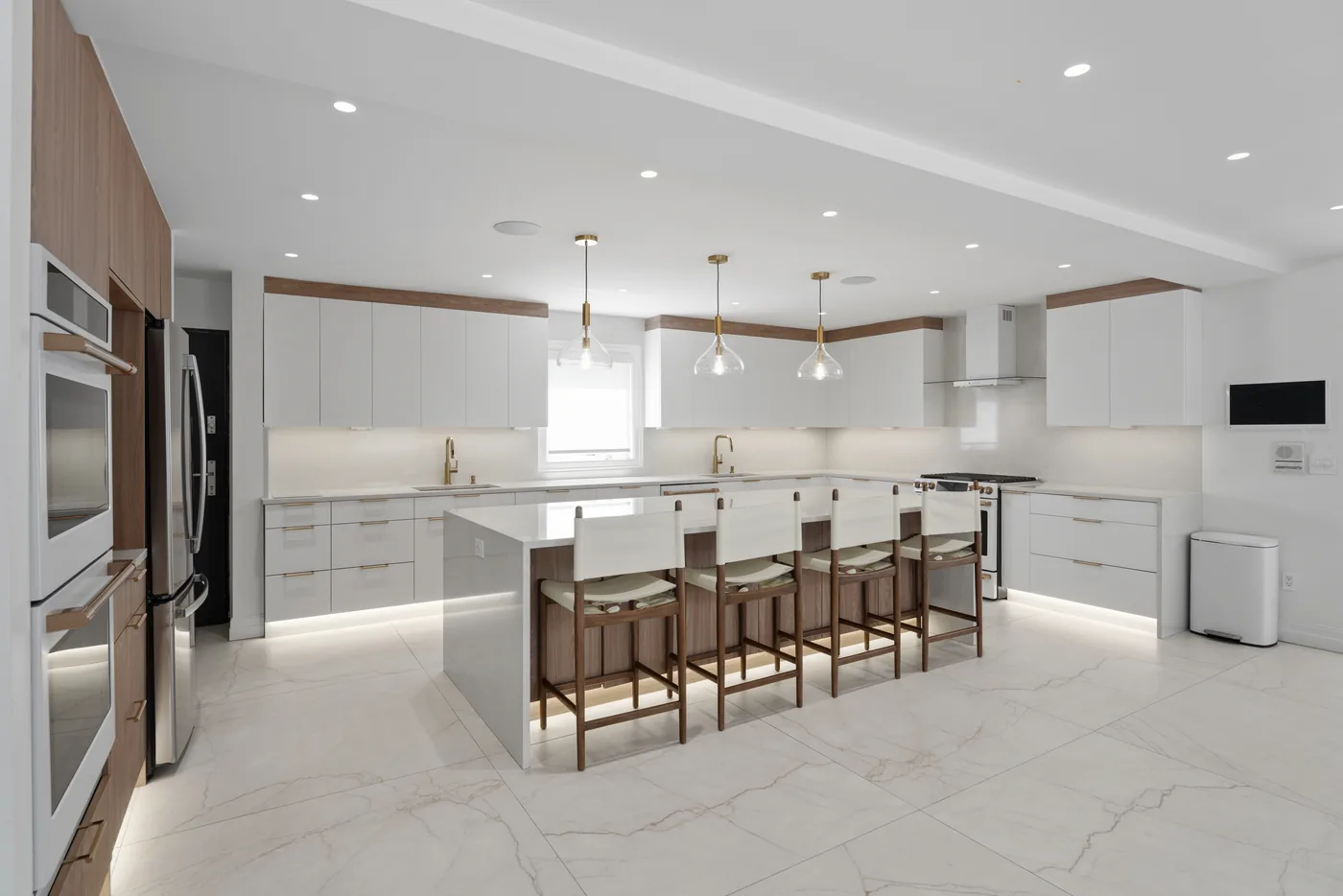 Wide view of a modern white kitchen photographed for a New York City real estate listing.