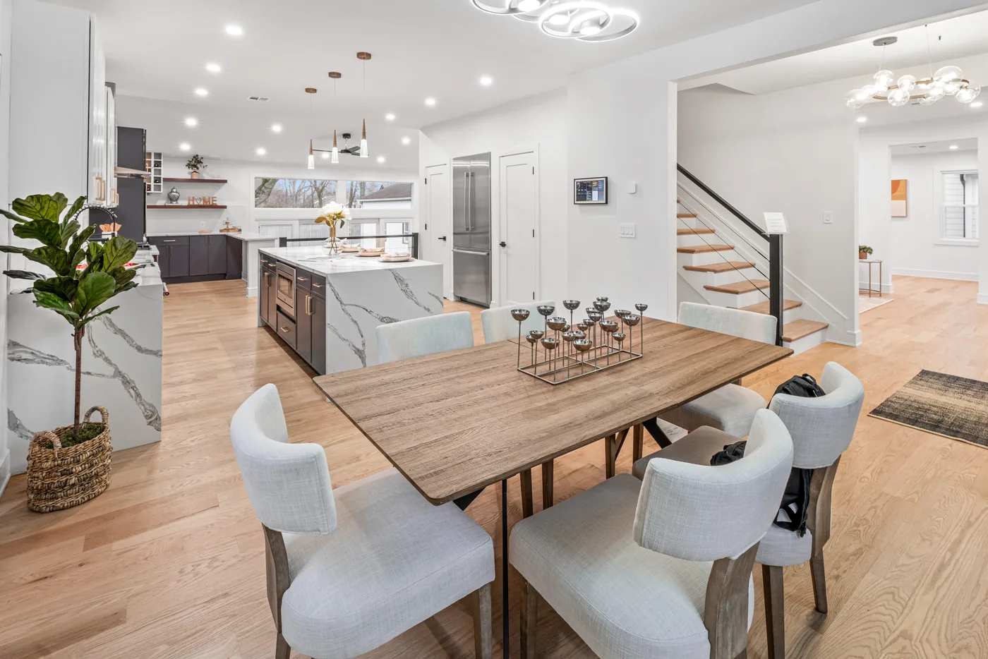 Open kitchen and dining area with marble island photographed for a New York City real estate listing.